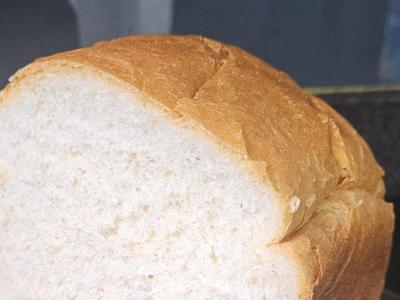 White sandwich loaf with one end sliced to show a soft, even crumb.